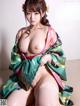 A woman in a kimono sitting on the floor.