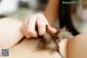 A close up of a woman's hand holding a feather.