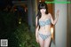 A woman in a bikini posing for a picture.